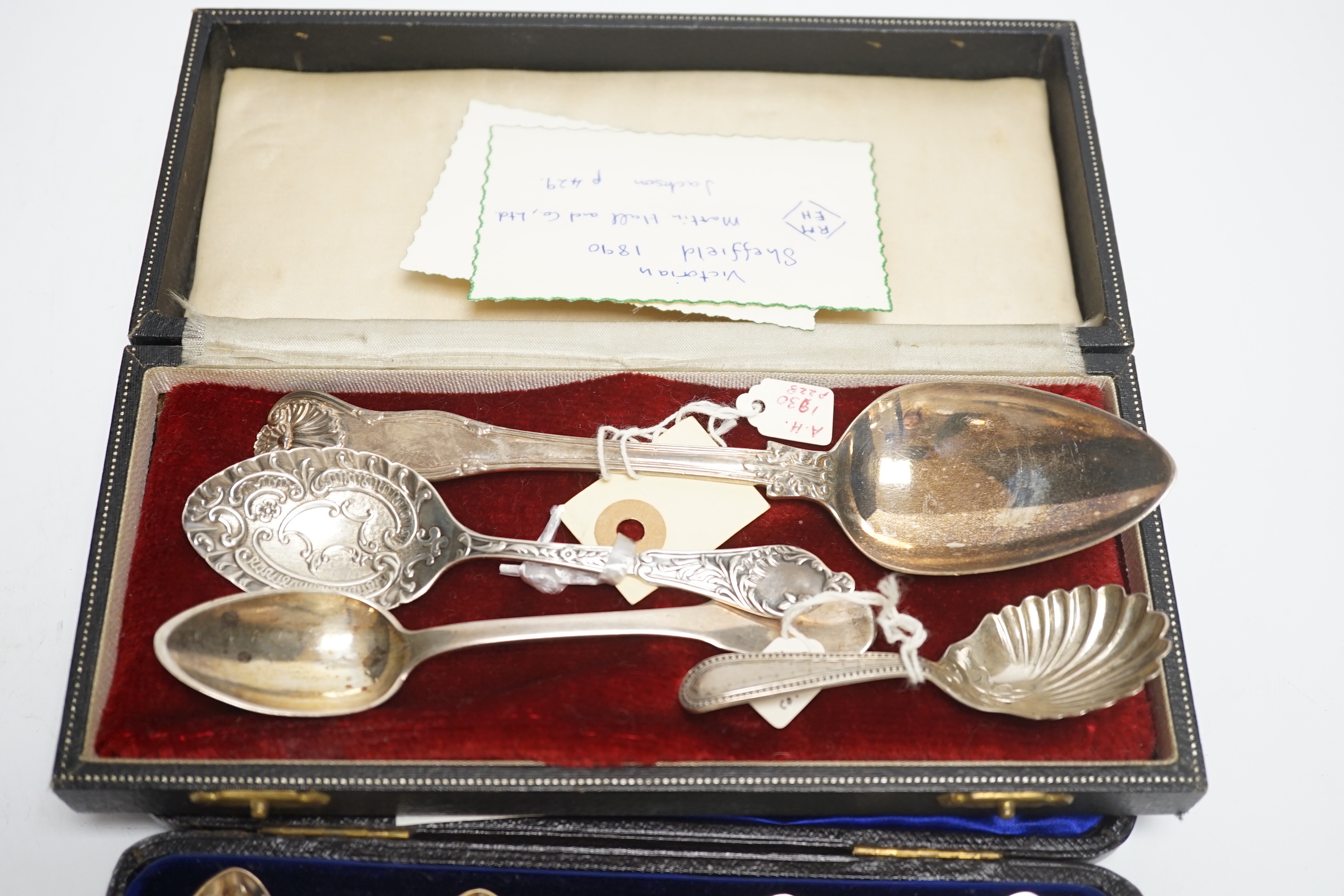 A cased set of six silver teaspoons and tongs and four other assorted silver or white metal spoons, including a caddy spoon.